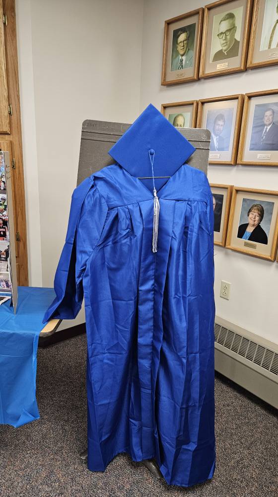 Royal blue graduation gown and cap with silver tassel