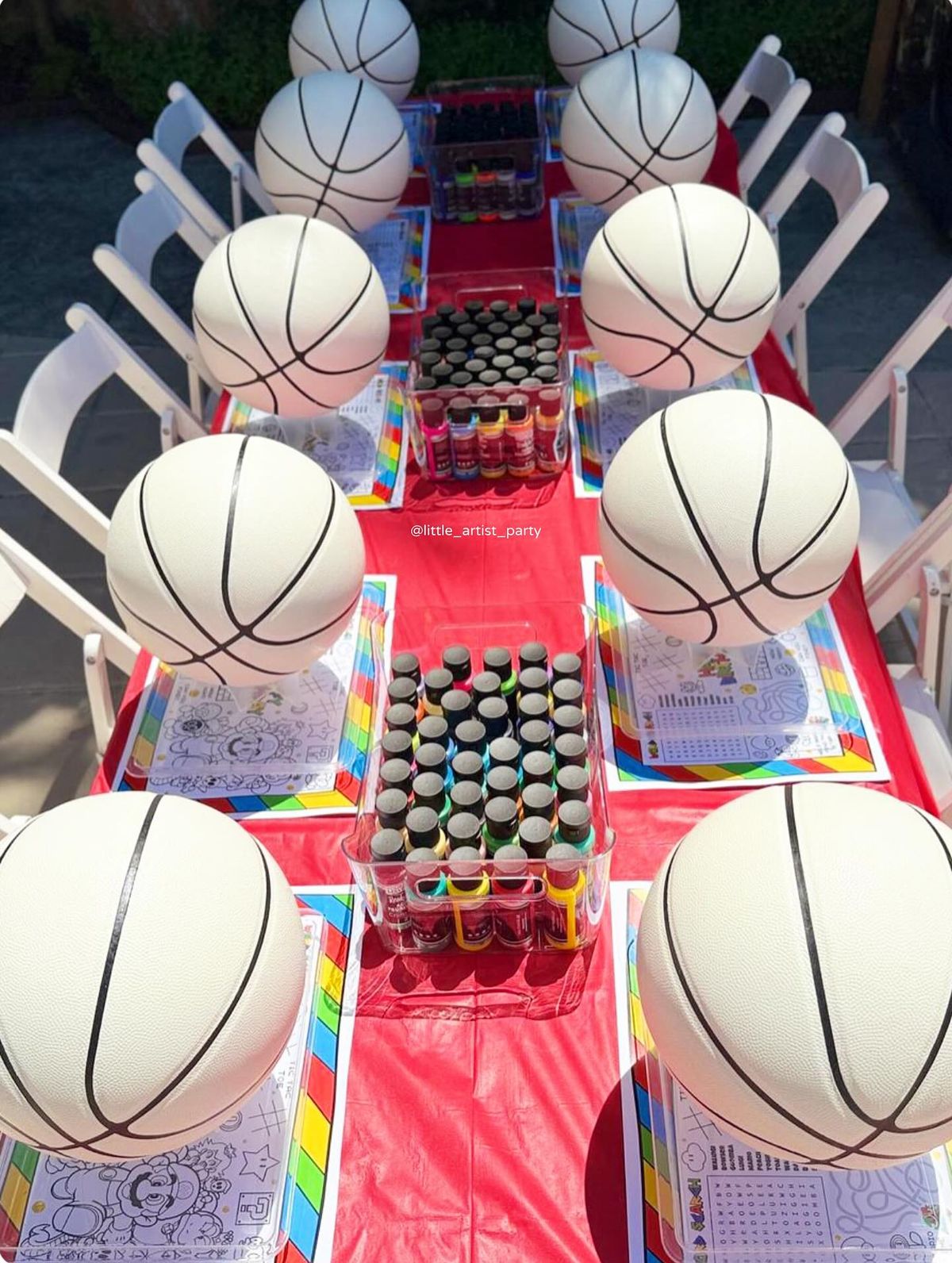 Basketball-themed craft party table with white foam basketballs and paint supplies set for children