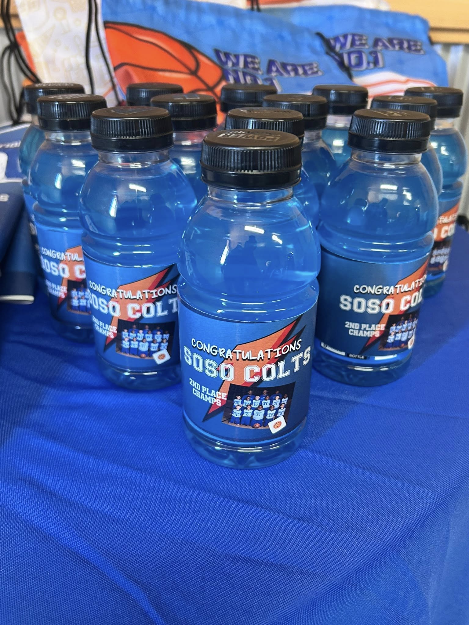 Blue sports drink bottles with custom labels celebrating Soso Colts 2nd place championship win.
