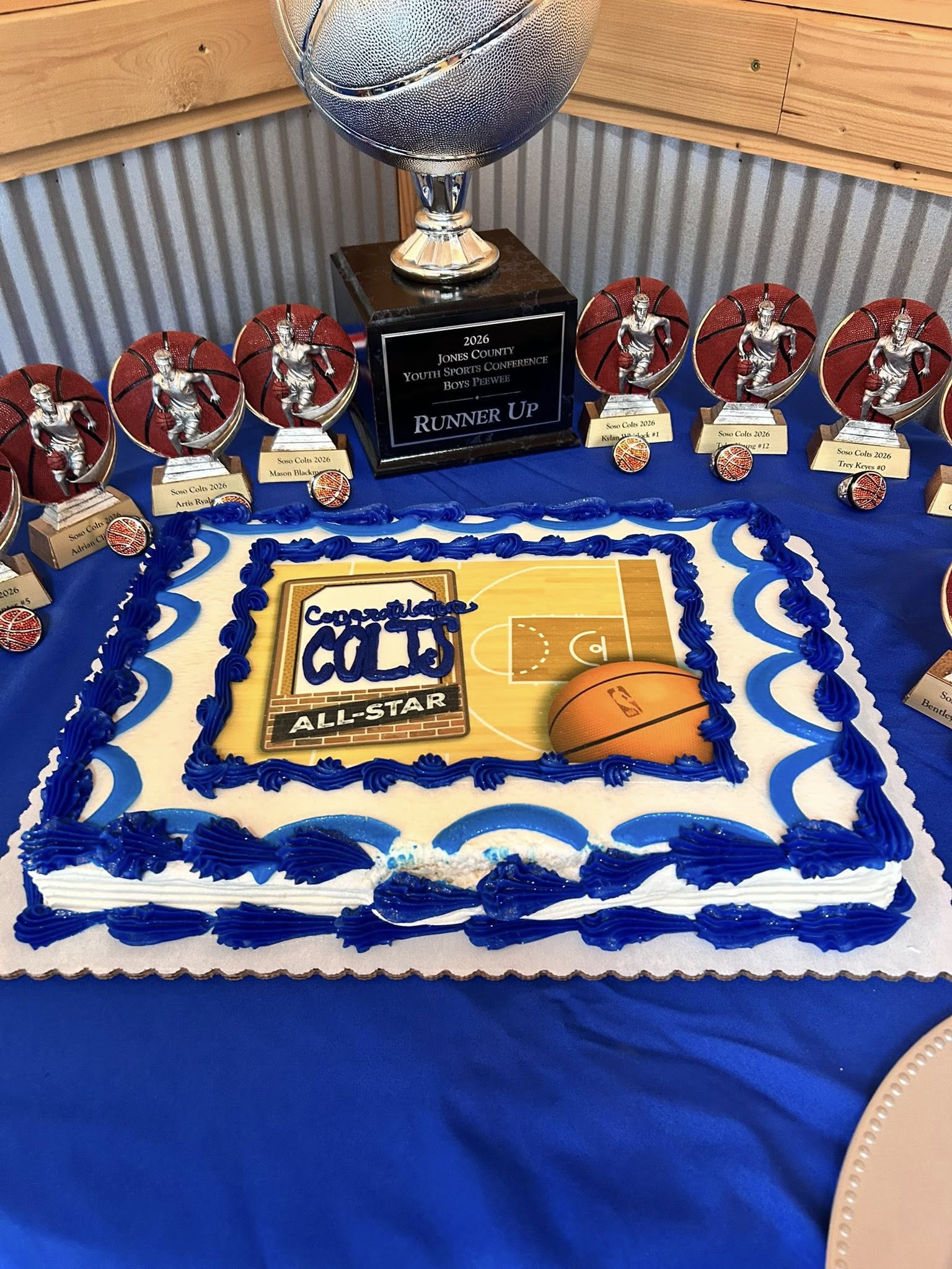 Basketball themed cake for the Soso Colts All-Star team next to player trophies and a runner up award.