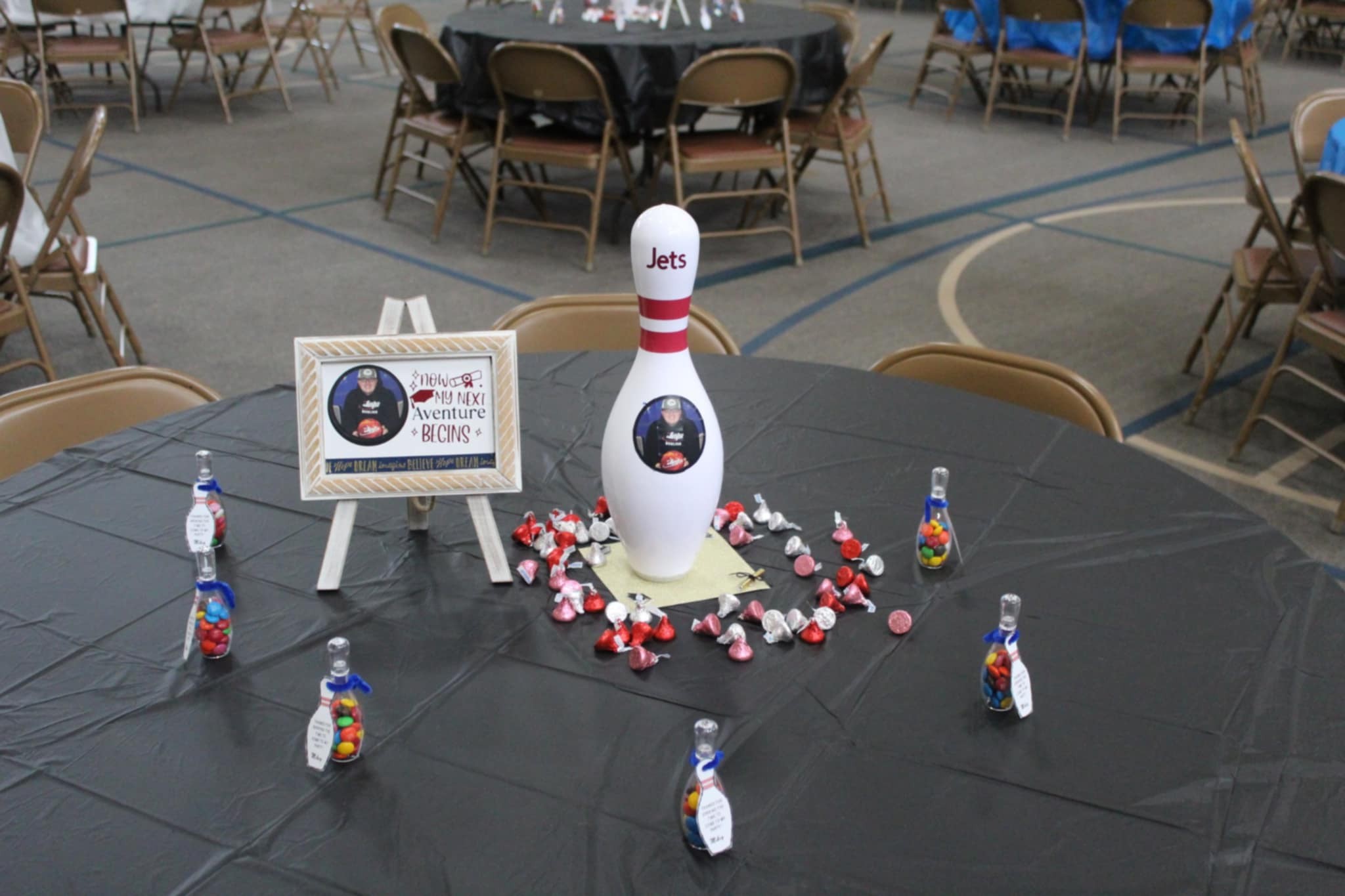 Bowling themed graduation table centerpiece with custom pin and chocolate candies.