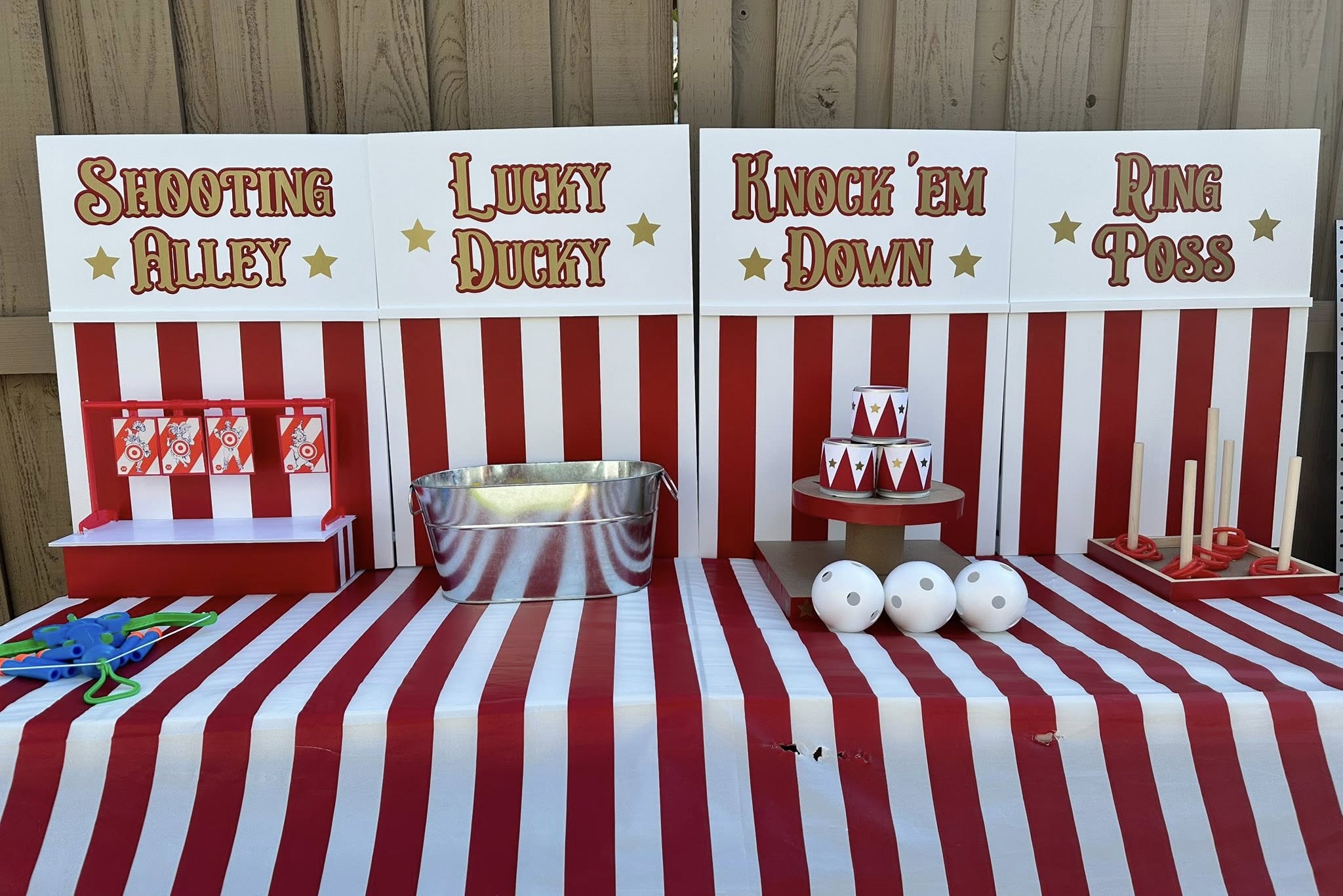 Set of four carnival-themed party games including Shooting Alley, Lucky Ducky, Knock 'Em Down, and Ring Toss.