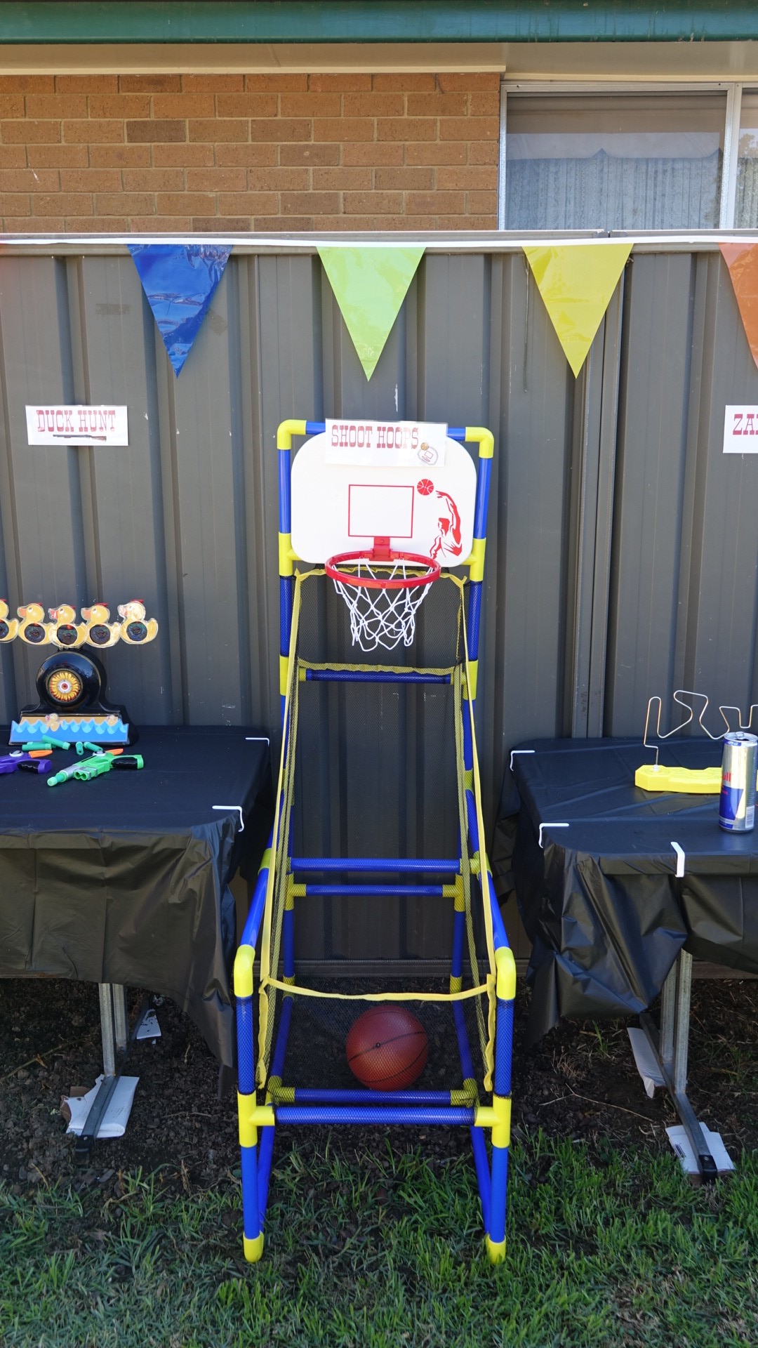 Portable indoor and outdoor basketball hoop arcade game with a ball, set up for a party activity.