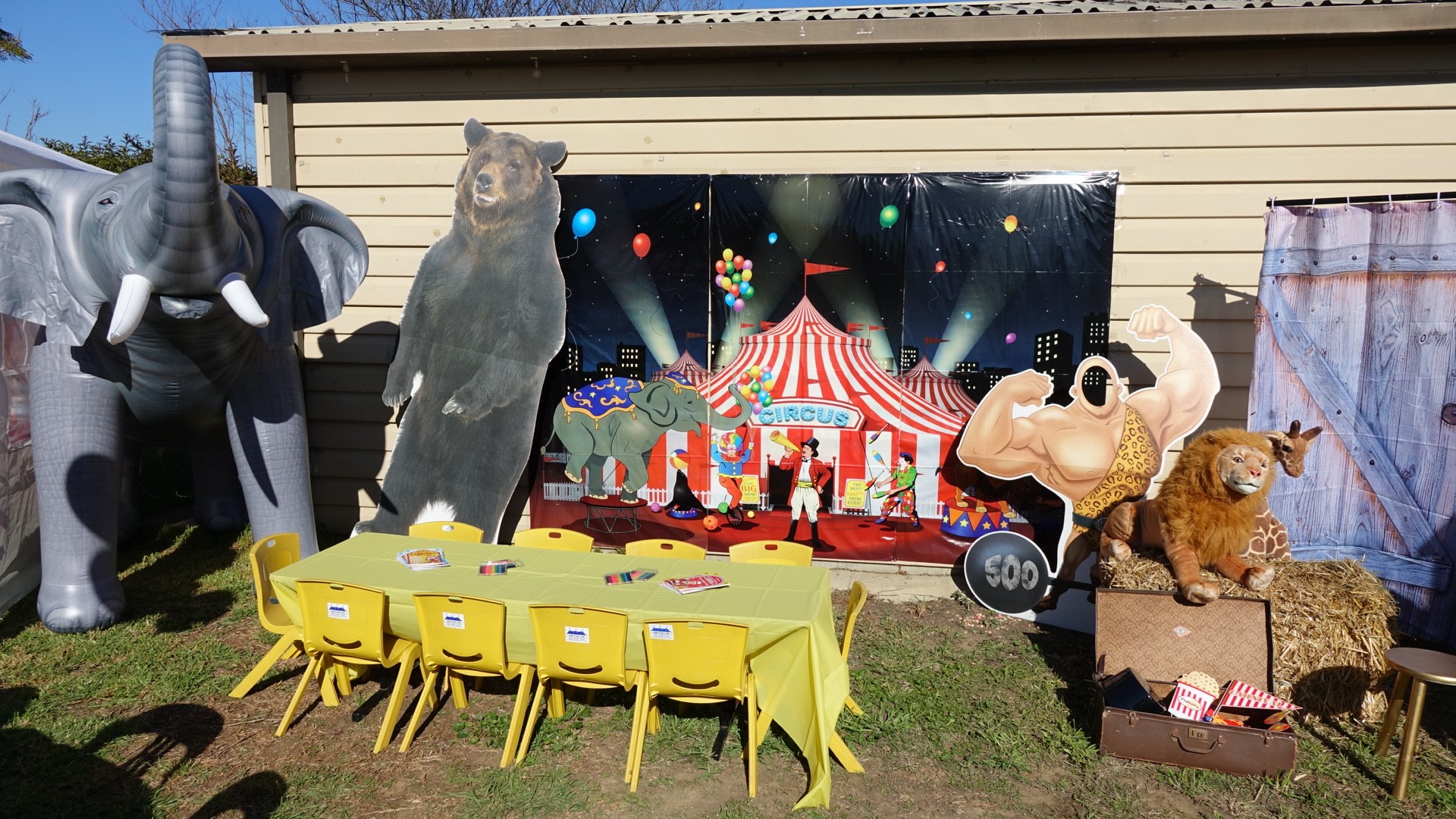 Circus-themed party table set up at a venue with elephant and bear decorations