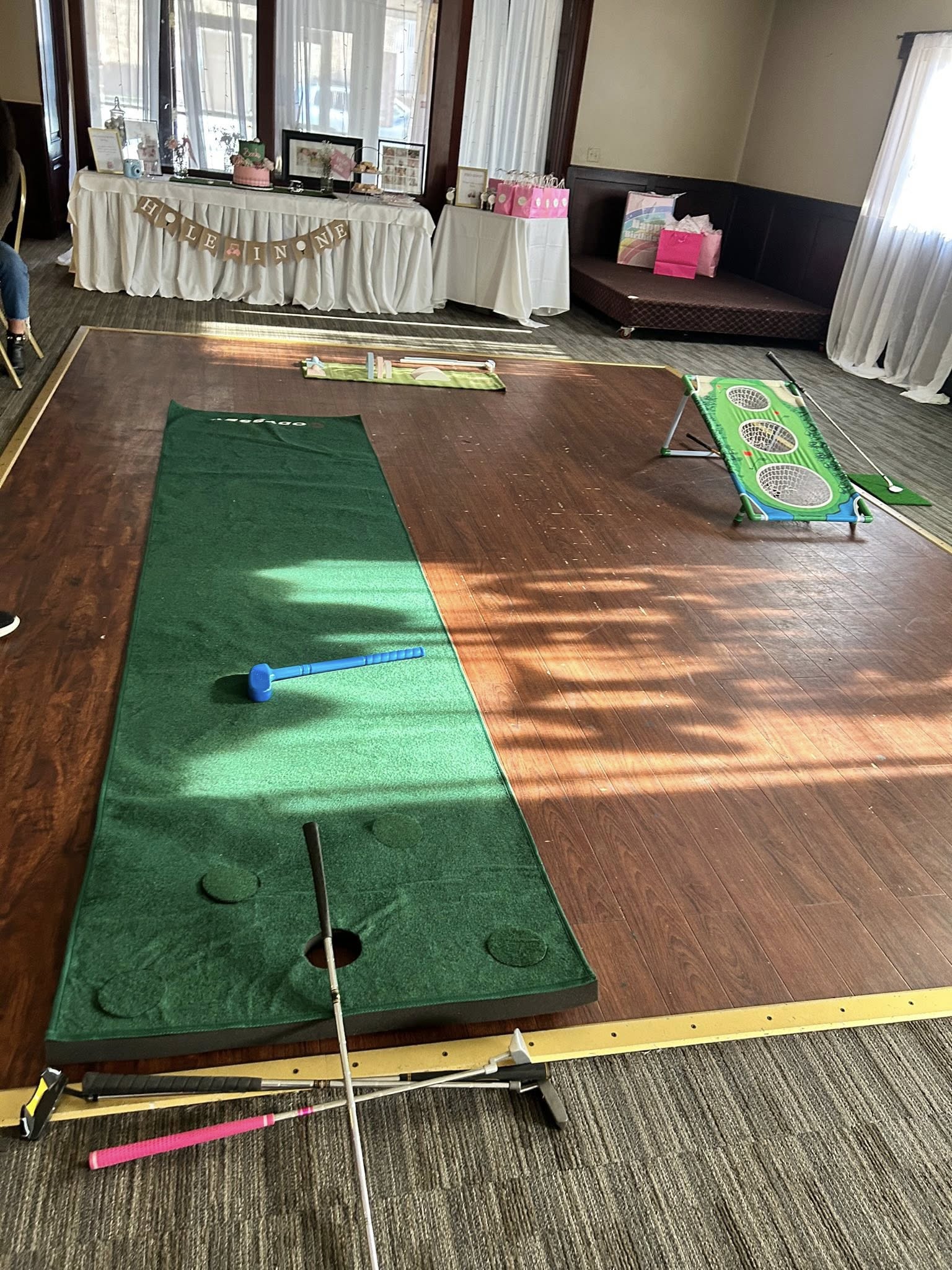 Indoor putting green and golf chipping game set up for a celebration.