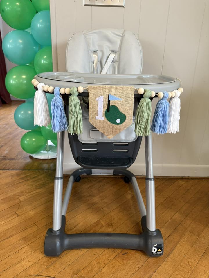 Golf-themed first birthday high chair banner with burlap, tassels, and a number one cutout