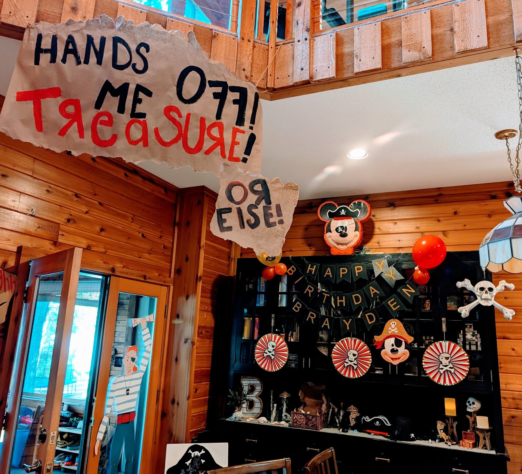 Pirate-themed birthday party decorations with a sign that says Hands Off Me Treasure Or Else