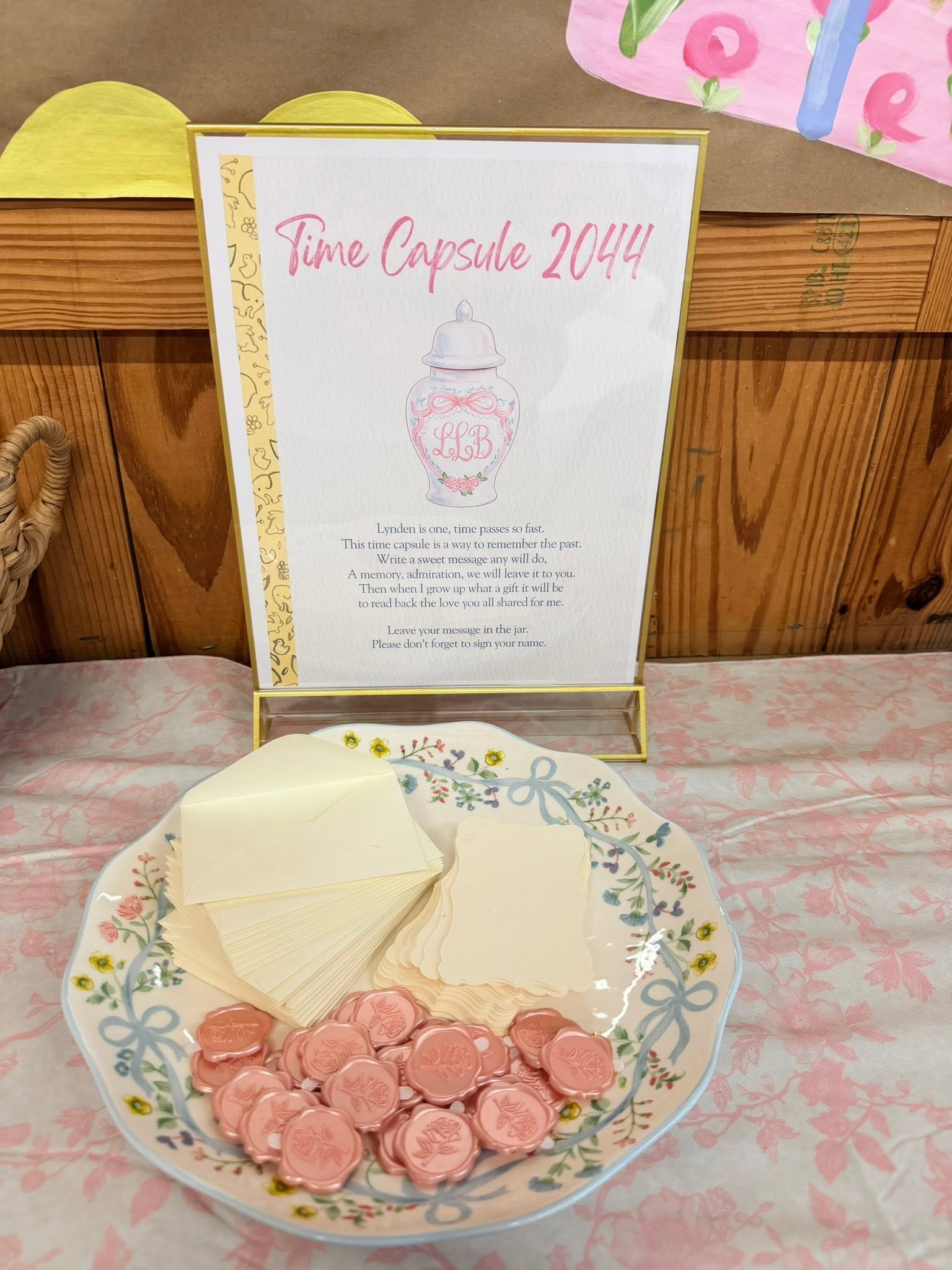 Time Capsule 2044 sign with a dish containing blank note cards and rose-shaped wax seals for guests.