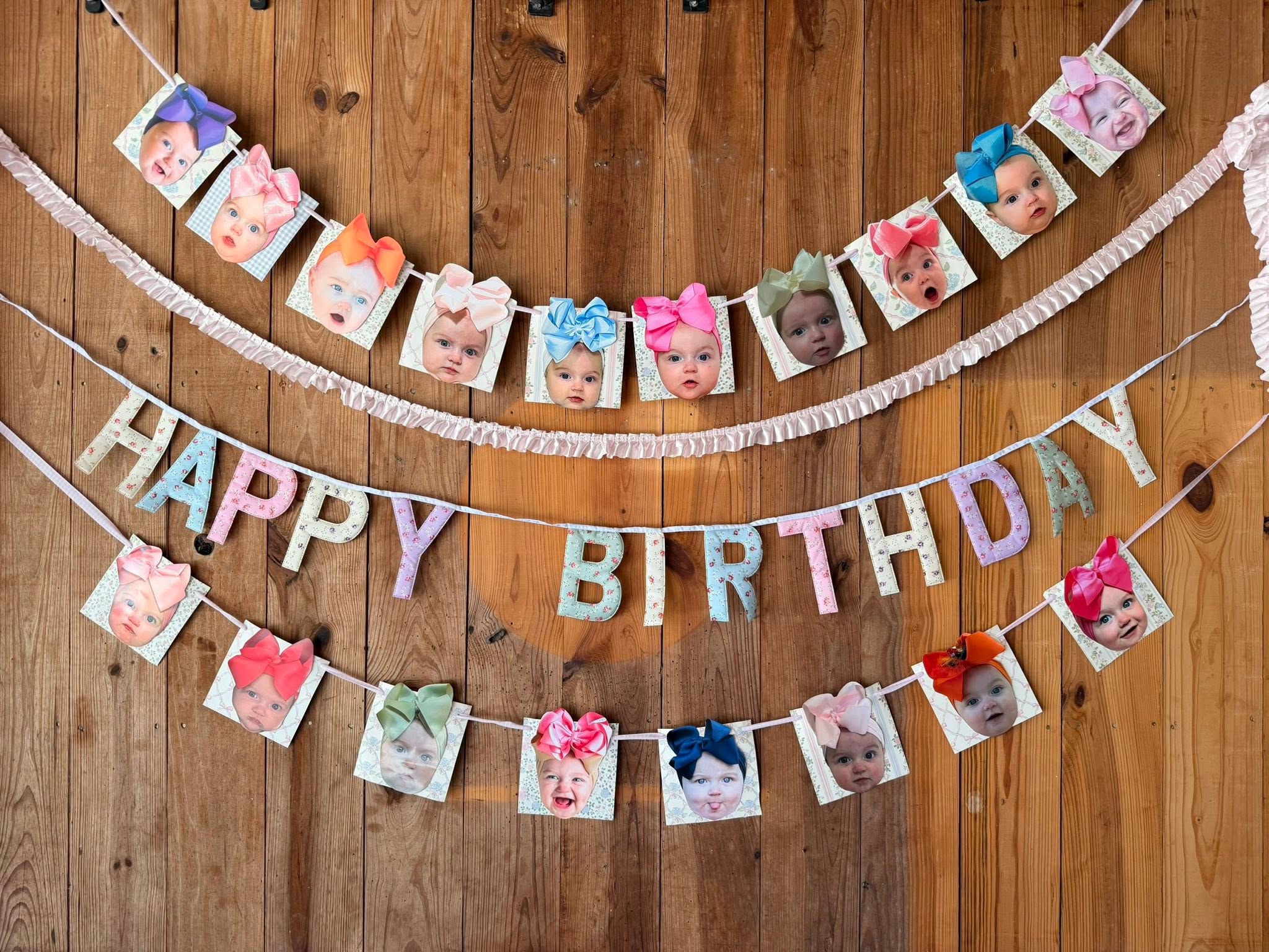Custom Happy Birthday banner featuring photo squares of a baby wearing various colorful hair bows.