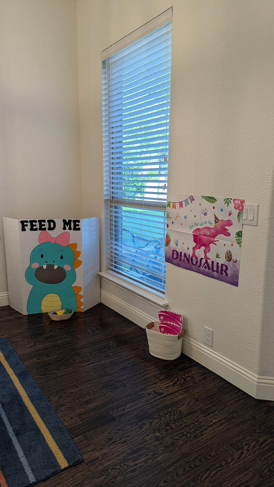 Dinosaur themed birthday party activities including a 'Feed Me' dinosaur game and a 'Pin the tail' poster.