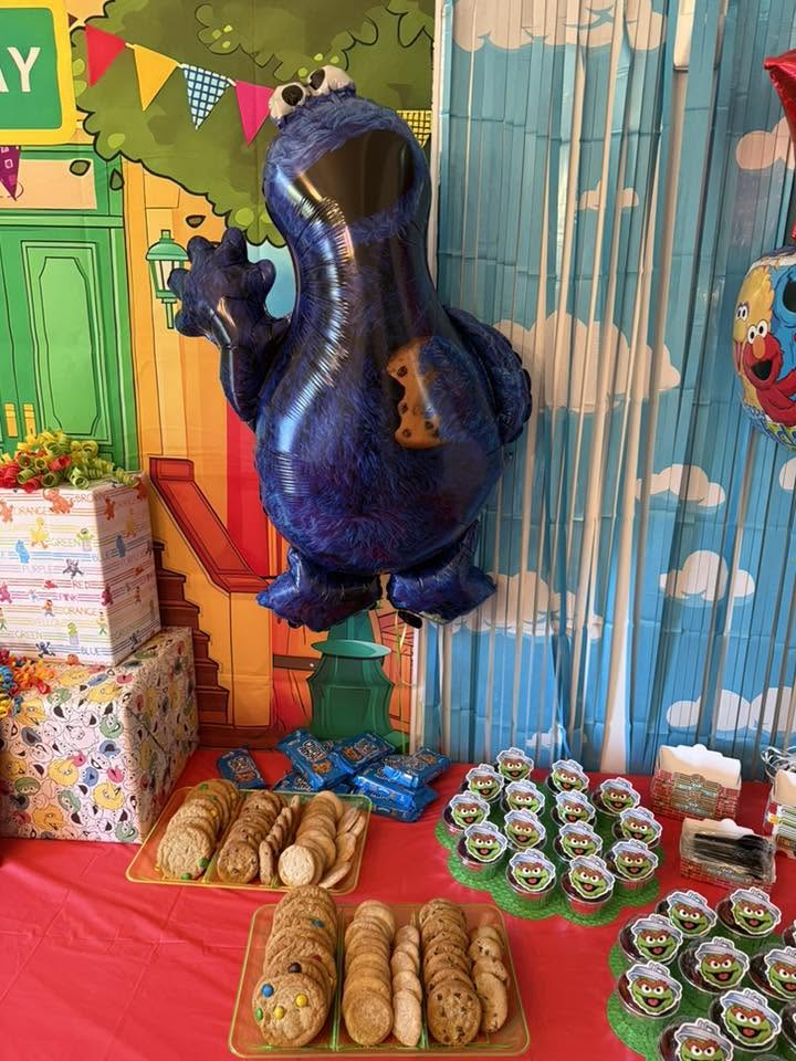 Cookie Monster balloon decoration at a Sesame Street themed party setup