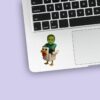 Custom Green Pixel Zombie Riding a Chicken Face Cutout – Sticker Custom Green Pixel Zombie Riding a Chicken Face Cutout shown on a sticker mockup