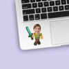 Custom Pixel Adventurer with Teal Sword Face Cutout – Sticker Custom Pixel Adventurer with Teal Sword Face Cutout shown on a sticker mockup