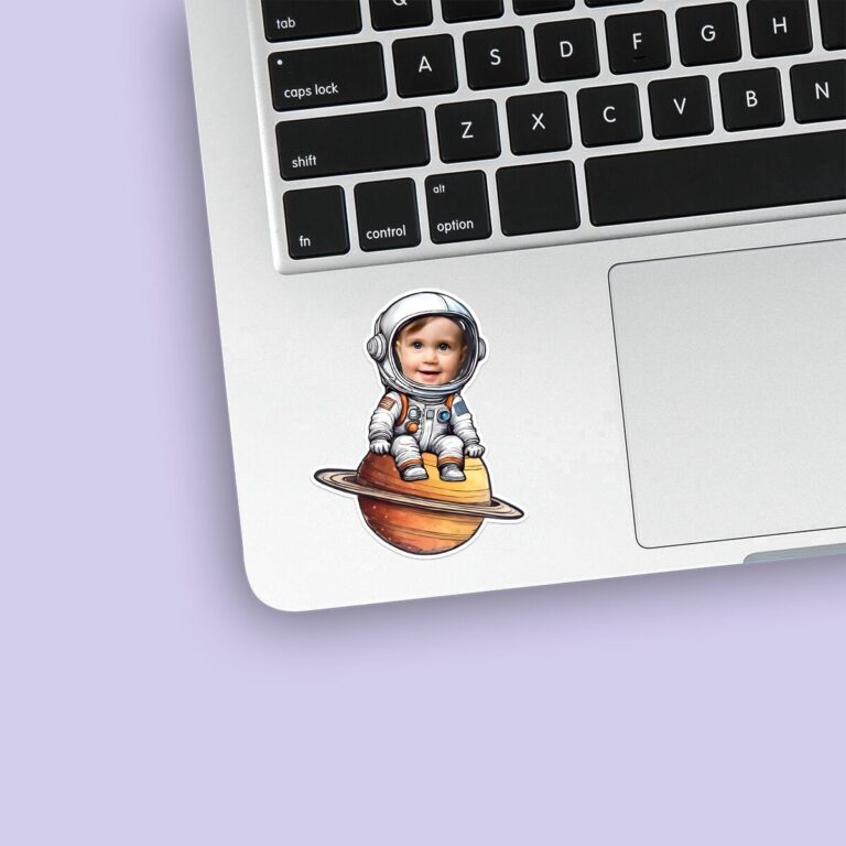 Custom Astronaut Seated on Saturn Face Cutout – Sticker Custom Astronaut Seated on Saturn Face Cutout shown on a sticker mockup