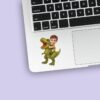 Custom Child Riding a Roaring Green Face Cutout – Sticker Custom Child Riding a Roaring Green Face Cutout shown on a sticker mockup