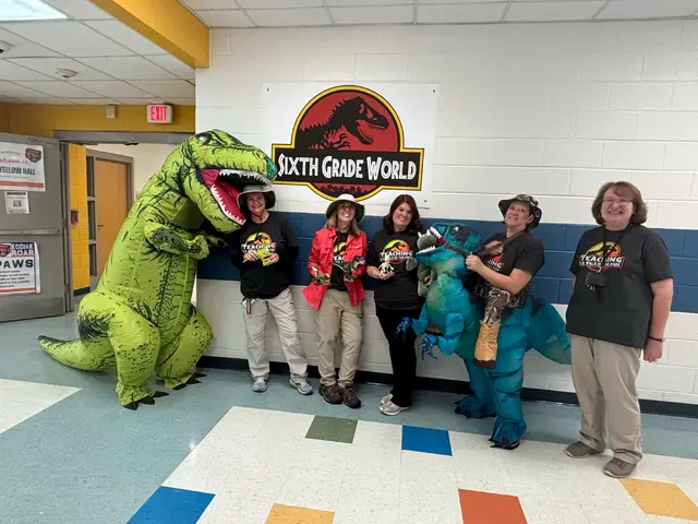Dinosaur Group Photo Setup with a Sixth Grade World Sign