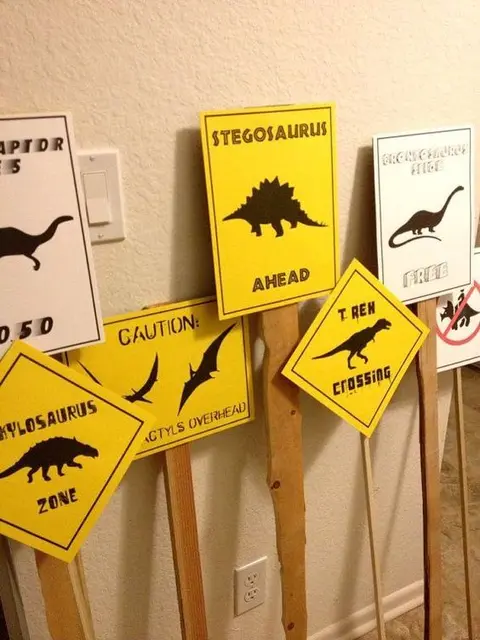Dinosaur Crossing and Caution Signs on Wooden Sticks