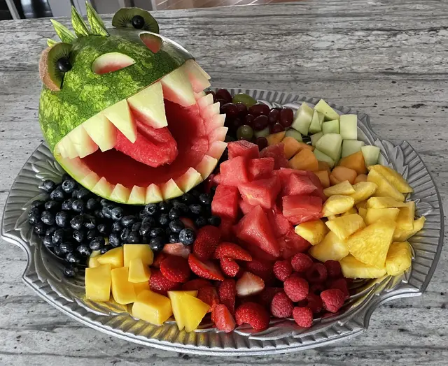 Toothy Watermelon Creature on a Colorful Fruit Platter