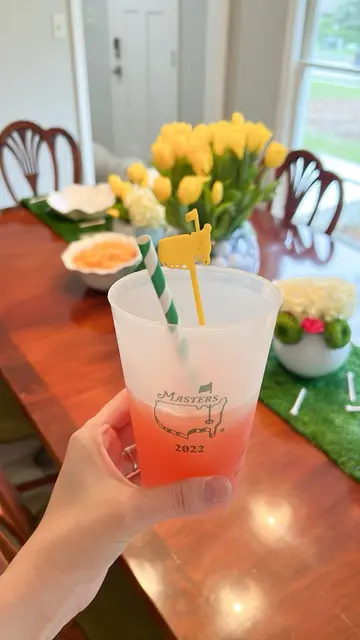 Masters Party Cup with a Striped Straw and Yellow Stirrer