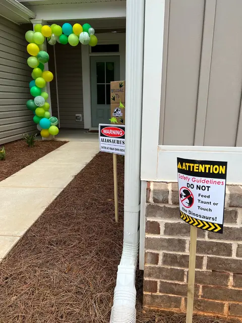 Dinosaur Entrance with Green and Yellow Balloons