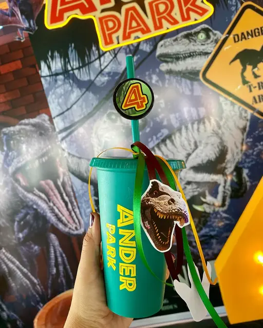 Green Dinosaur Cup with Ribbons and a Number 4 Topper