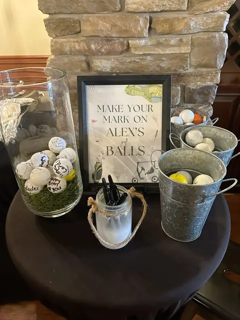 Golf Ball Guest Book Table with Buckets and a Framed Sign