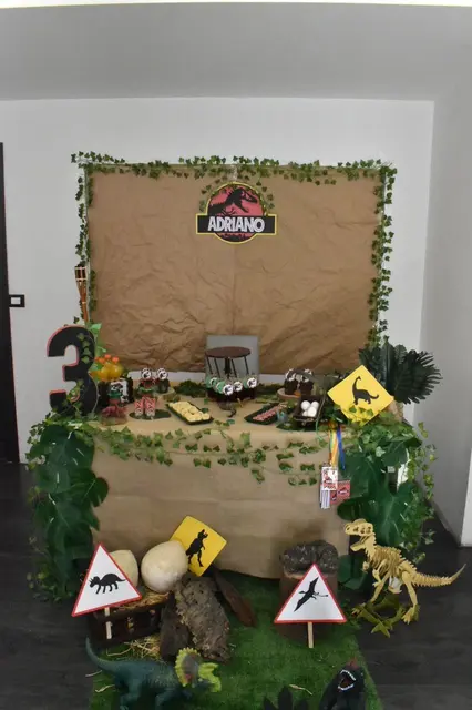 Dinosaur Dessert Table with Paper Signs and a Name Backdrop