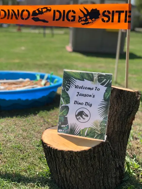 Dino Dig Welcome Sign on a Tree Stump