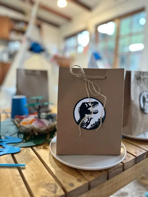 Brown Dinosaur Favor Bag at a Party Place Setting