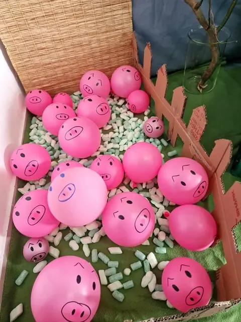 Pig Balloon Display with a Cardboard Fence