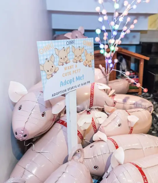 Pig Balloon Adoption Station with a Blue Gingham Sign