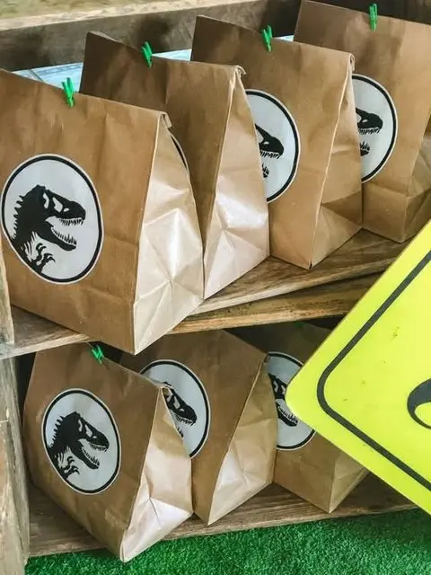 Dinosaur Favor Bags with Green Clips on Shelves