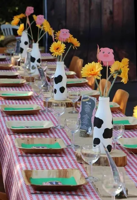 Cow-Print Bottle Centerpieces with Yellow Flowers and Pig Picks