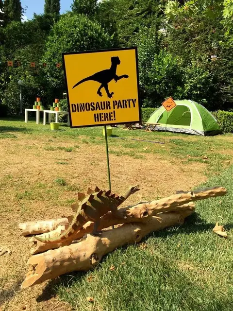 Yellow Dinosaur Party Sign with a Log Display